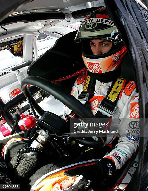 Joey Logano, driver of the The Home Depot Toyota, sits in his car during practice for the NASCAR Sprint Cup Series Autism Speaks 400 at Dover...