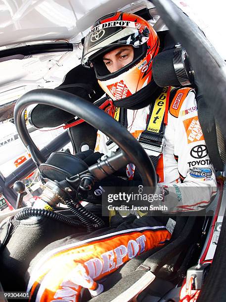 Joey Logano, driver of the The Home Depot Toyota, sits in his car during practice for the NASCAR Sprint Cup Series Autism Speaks 400 at Dover...