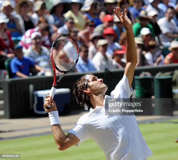 Roger Federer of Switzerland serves against Jurgen Melzer of Austria in the Mens Singles fourth round on day seven of the 2010 Wimbledon...