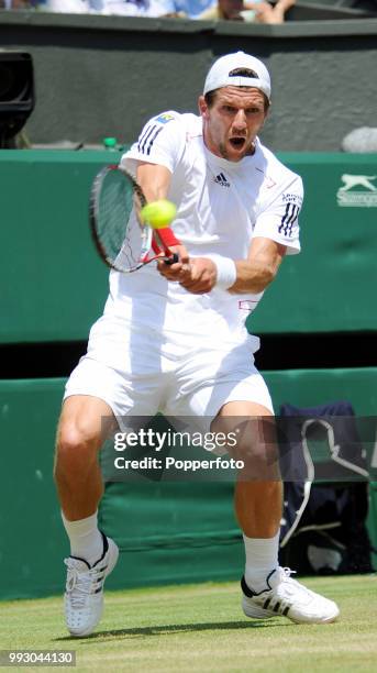 Jurgen Melzer of Austria returns the ball against Roger Federer of Switzerland in the Mens Singles fourth round on day seven of the 2010 Wimbledon...