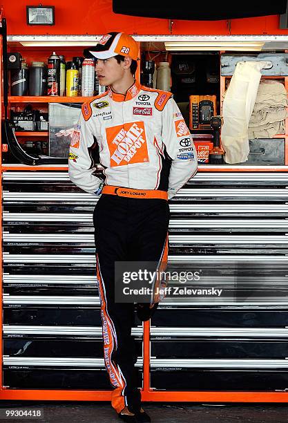 Joey Logano, driver of the The Home Depot Toyota, stands in the garage during practice for the NASCAR Sprint Cup Series Autism Speaks 400 at Dover...