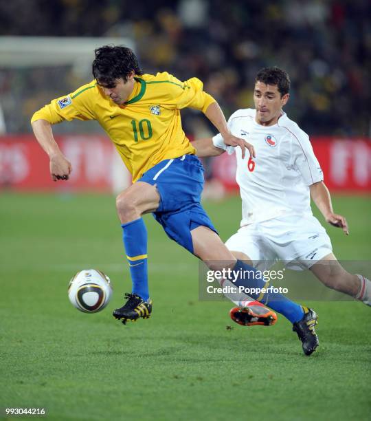 Kaka of Brazil is closed down by Carlos Carmona of Chile during a FIFA World Cup Round of 16 match at Ellis Park on June 28, 2010 in Johannesburg,...