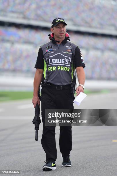 Chad Knaus, crew chief for Jimmie Johnson, driver of the Lowe's for Pros Chevrolet, walks down pit road during qualifying for the Monster Energy...
