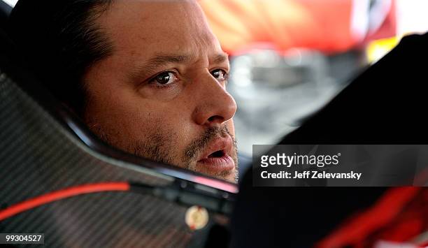 Tony Stewart, driver of the Office Depot Chevrolet, sits in his car during practice for the NASCAR Sprint Cup Series Autism Speaks 400 at Dover...