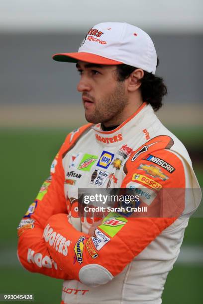 Chase Elliott, driver of the Hooters Chevrolet, stands by his car during qualifying for the Monster Energy NASCAR Cup Series Coke Zero Sugar 400 at...