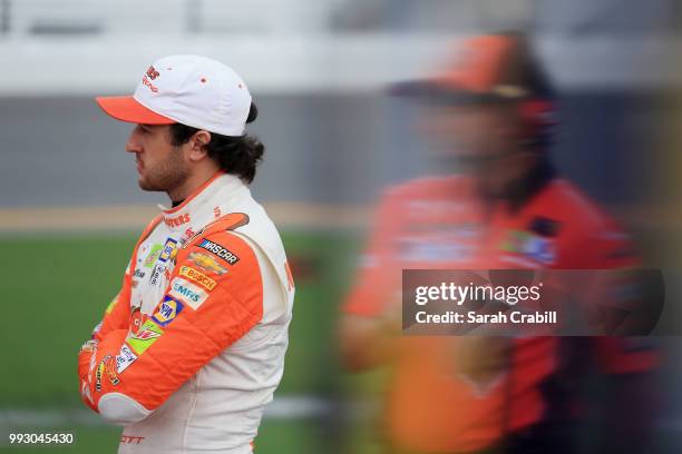 Chase Elliott, driver of the Hooters Chevrolet, stands by his car during qualifying for the Monster Energy NASCAR Cup Series Coke Zero Sugar 400 at...