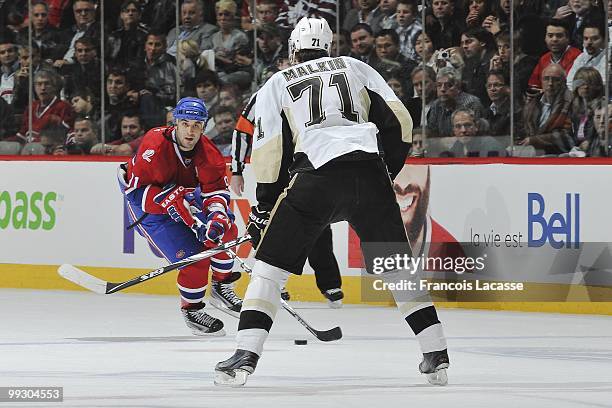 Scott Gomez of Montreal Canadiens skates with the puck in front of Evgeni Malkin of the Pittsburgh Penguins in Game Six of the Eastern Conference...