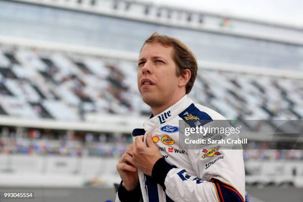 Brad Keselowski, driver of the Stars Stripes and Lites Ford, stands by his car during qualifying for the Monster Energy NASCAR Cup Series Coke Zero...