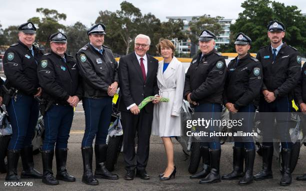 Federal President Frank-Walter Steinmeier and his wife Elke Buedenbender standing before their flight to New Zealnd accompanied by police officers in...