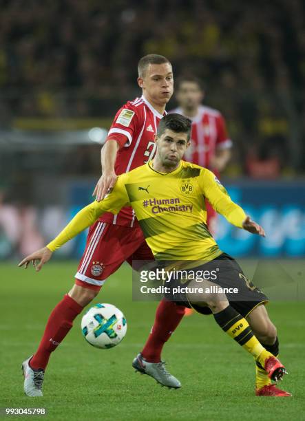 Dortmund's Christian Pulisic and Bayern's Joshua Kimmich vie for the ball during the German Bundesliga soccer match between Borussia Dortmund and...