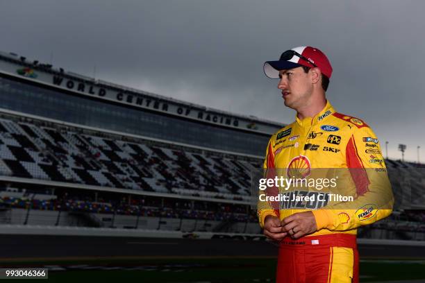 Joey Logano, driver of the Shell Pennzoil Ford, walks on the grid during qualifying for the Monster Energy NASCAR Cup Series Coke Zero Sugar 400 at...