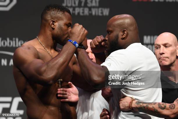 Opponents Francis Ngannou of Cameroon and Derrick Lewis face off during the UFC 226 weigh-in inside T-Mobile Arena on July 6, 2018 in Las Vegas,...
