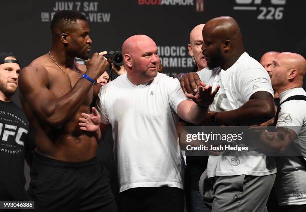 Opponents Francis Ngannou of Cameroon and Derrick Lewis face off during the UFC 226 weigh-in inside T-Mobile Arena on July 6, 2018 in Las Vegas,...