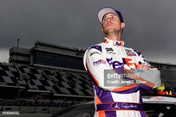 Denny Hamlin, driver of the FexEx Cares Toyota, stands on the grid during qualifying for the Monster Energy NASCAR Cup Series Coke Zero Sugar 400 at...