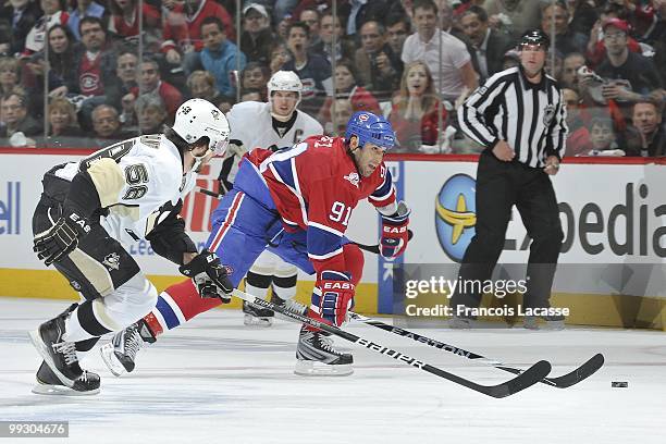 Scott Gomez of Montreal Canadiens skates with the puck in front of Kris Letang of the Pittsburgh Penguins in Game Six of the Eastern Conference...