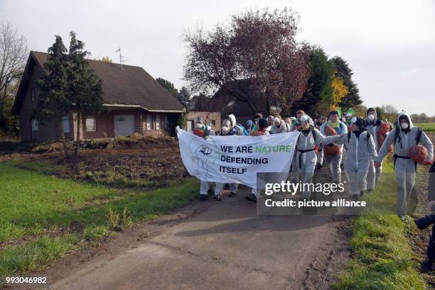 Participants of the coalition for action protest "Ende Gelaende" pass the demolition location Mannheim in Kerpen, Germany, 05 November 2017. One day...
