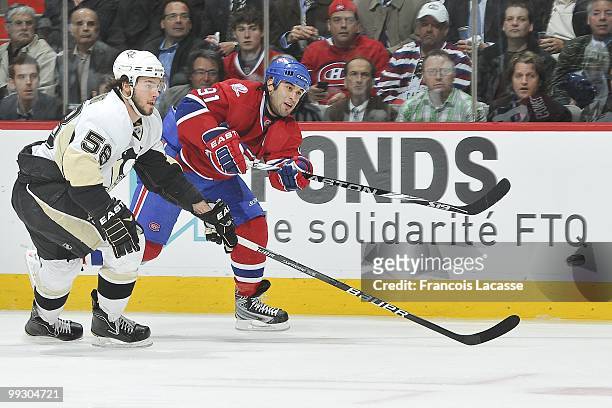 Scott Gomez of Montreal Canadiens takes a shot in front of Kris Letang of the Pittsburgh Penguins in Game Six of the Eastern Conference Semifinals...