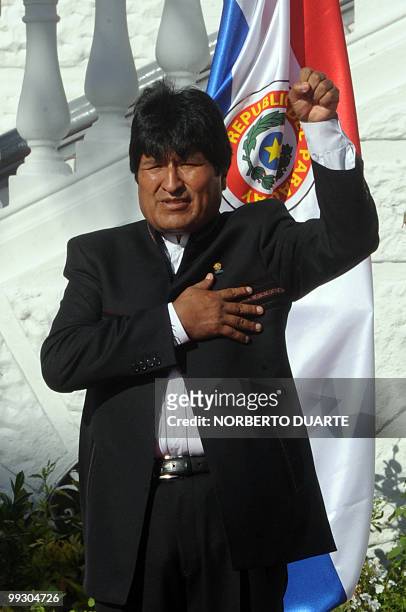 Bolivia's President Evo Morales raises his fist as him and his Paraguayan counterpart Fernando Lugo listen to their respective national anthems at...