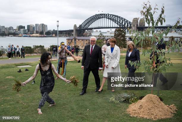 German President Frank-Walter Steinmeier and his wife Elke Buedenbender watch as a group of Australian Aboriginals perform during their visit to the...
