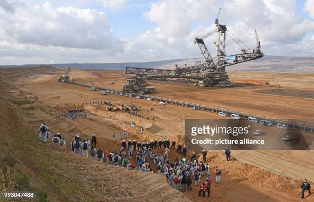 Police officers stand guard as activists from the 'Ende Gelaende' group gather to blockade coal operations at the strip mine of Hambach in Kerpen,...