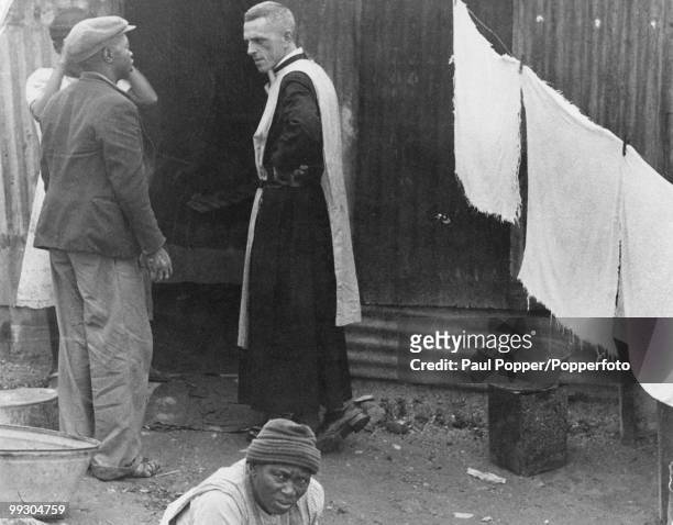 British Anglican priest and anti-Apartheid activist Trevor Huddleston talking to residents of a slum area in Newclare, Johannesburg, South Africa,...