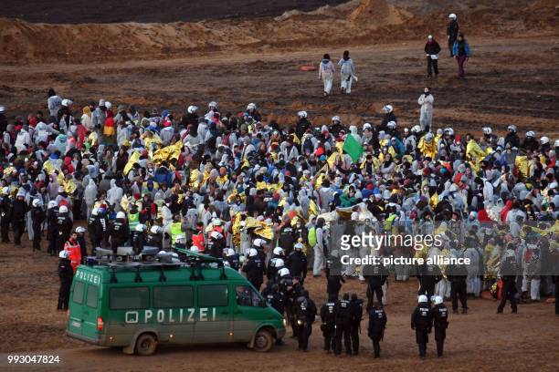 Participants of a demonstration of the campaign alliance 'Ende Gelaende' are surrounded by the police and wait to be transported by buses off-road...