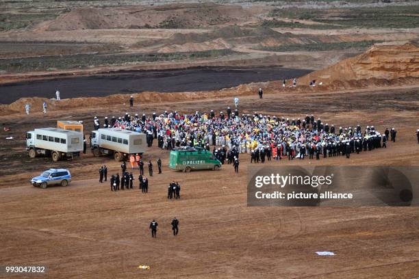 Participants of a demonstration of the campaign alliance 'Ende Gelaende' are surrounded by the police and wait to be transported by buses off-road...