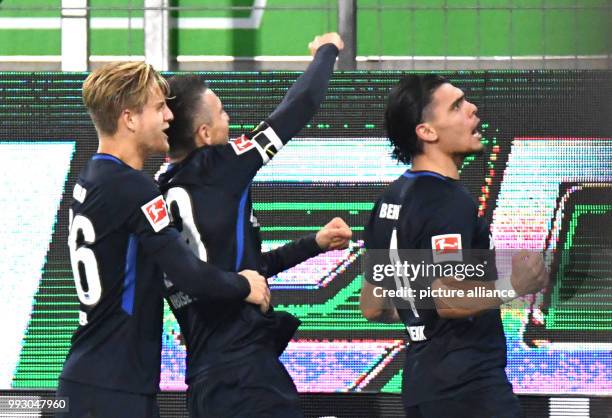 Berlin's Karim Rekik celebrates his 2:2 goal with Arne Maier and Vedad Ibisevic during the German Bundesliga soccer match between VfL Wolfsburg and...