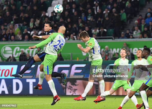Berlin's Karim Rekik shoots the 2:2 goal next to Wolfsburg's John Anthony Brooks during the German Bundesliga soccer match between VfL Wolfsburg and...