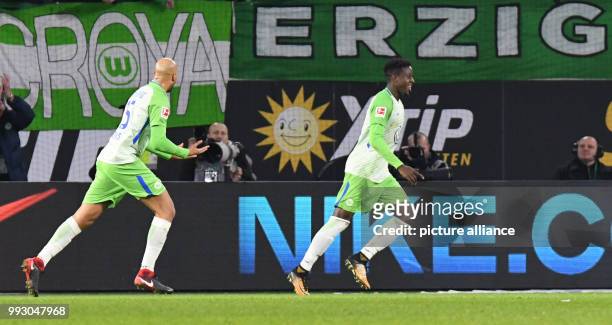 Wolfsburg's Divock Origi celebrates his 3:2 with John Anthony Brooks during the German Bundesliga soccer match between VfL Wolfsburg and Hertha BSC...