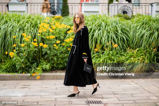 Swantje Soemmer wearing black dress, bag with print pouch seen outside Der Berliner Salon during the Berlin Fashion Week July 2018 on July 6, 2018 in...