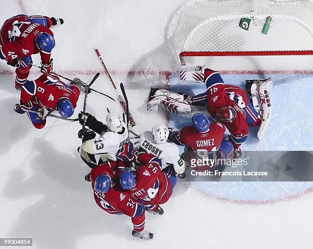 Scott Gomez of Montreal Canadiens battles for the puck with Sidney Crosby of the Pittsburgh Penguins in front of Jaroslav Halak of Montreal Canadiens...