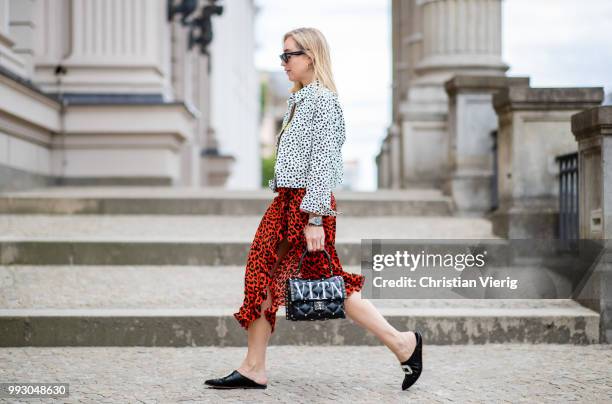 Sonia Lyson wearing Topshop jacket, top and skirt with animal print, Valentino bag seen during the Berlin Fashion Week July 2018 on July 6, 2018 in...