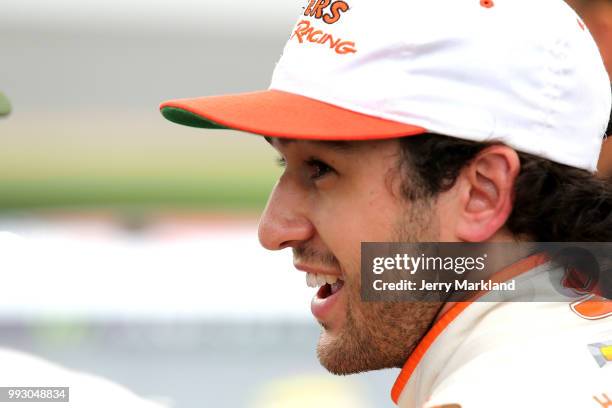 Chase Elliott, driver of the Hooters Chevrolet, stands by his car during qualifying for the Monster Energy NASCAR Cup Series Coke Zero Sugar 400 at...