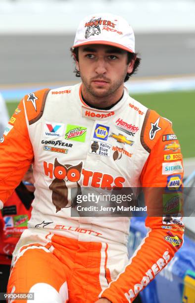 Chase Elliott, driver of the Hooters Chevrolet, stands by his car during qualifying for the Monster Energy NASCAR Cup Series Coke Zero Sugar 400 at...