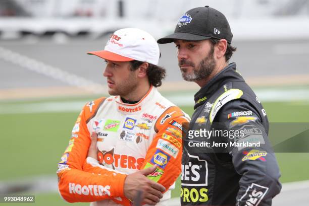 Chase Elliott, driver of the Hooters Chevrolet, talks with Jimmie Johnson, driver of the Lowe's for Pros Chevrolet, during qualifying for the Monster...