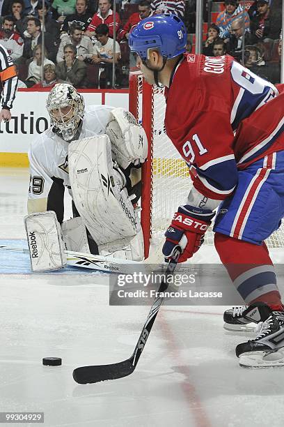 Scott Gomez of Montreal Canadiens takes a shot on goalie Marc-Andre Fleury of the Pittsburgh Penguins in Game Six of the Eastern Conference...