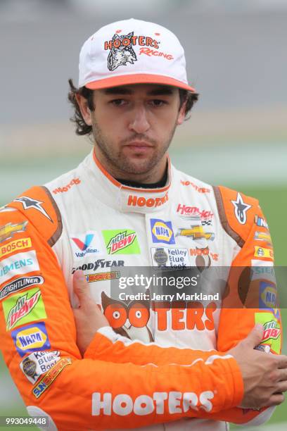 Chase Elliott, driver of the Hooters Chevrolet, stands by his car during qualifying for the Monster Energy NASCAR Cup Series Coke Zero Sugar 400 at...