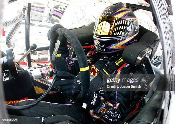 Matt Kenseth, driver of the Crown Royal Black Ford, sits in his car during practice for the NASCAR Sprint Cup Series Autism Speaks 400 at Dover...