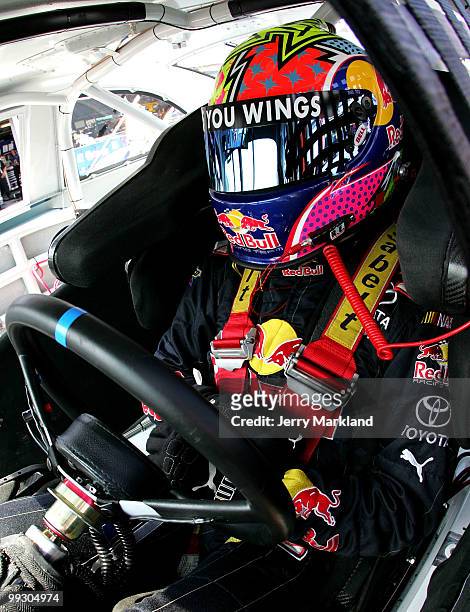 Scott Speed, driver of the Red Bull Toyota, sits in his car during practice for the NASCAR Sprint Cup Series Autism Speaks 400 at Dover International...