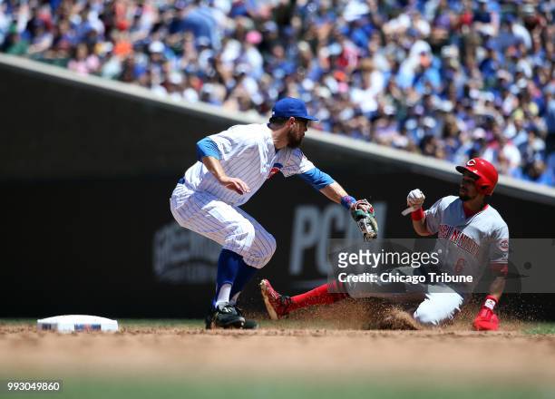 Chicago Cubs infielder Ben Zobrist applies the tag as the Cincinnati Reds' Billy Hamilton is caught stealing second base in the third inning at...