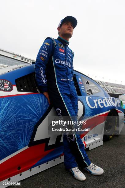 Kyle Larson, driver of the Credit One Bank Chevrolet, waits by his car during qualifying for the Monster Energy NASCAR Cup Series Coke Zero Sugar 400...