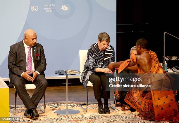 The COP23 president and prime minister of the Fiji Islands Frank Bainimarama observes handing out of the present for the climate minister Barbara...