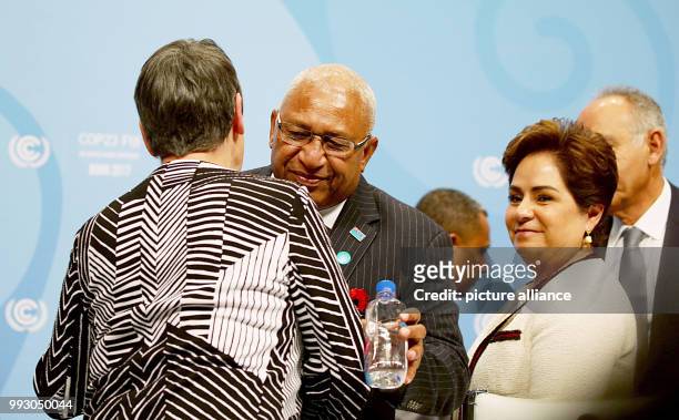 The COP23 president and prime minister of the Fiji Islands Frank Bainimarama hugs the German climate minister Barbara Hendrickduring the opening of...