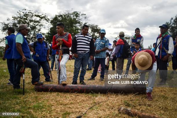 Indigenous people of the Nasa ethnic group destroy a homemade rocket launcher seized from ELN guerrillas, on July 6 in Corinto, Cauca department,...