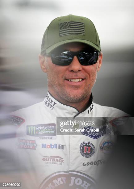 Kevin Harvick, driver of the Jimmy John's Kickin' Ranch Ford, stands by his car during qualifying for the Monster Energy NASCAR Cup Series Coke Zero...