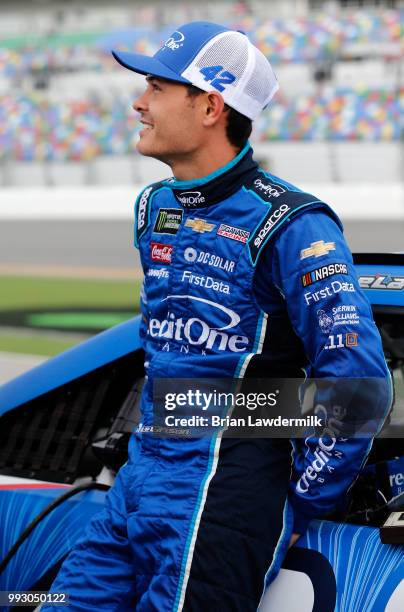 Kyle Larson, driver of the Credit One Bank Chevrolet, waits by his car during qualifying for the Monster Energy NASCAR Cup Series Coke Zero Sugar 400...