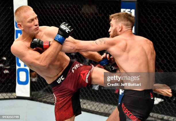 Gerald Meerschaert punches Oskar Piechota of Poland in their middleweight bout during The Ultimate Fighter Finale event inside The Pearl concert...