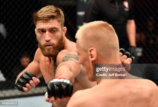 Gerald Meerschaert punches Oskar Piechota of Poland in their middleweight bout during The Ultimate Fighter Finale event inside The Pearl concert...