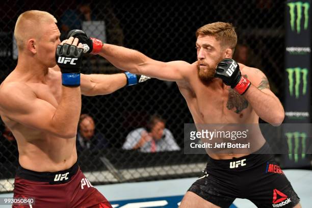 Gerald Meerschaert punches Oskar Piechota of Poland in their middleweight bout during The Ultimate Fighter Finale event inside The Pearl concert...